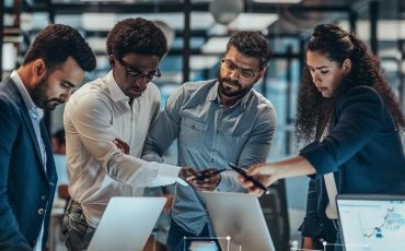 IT professionals collaborating in a modern office, emphasizing managed IT services and teamwork