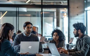 Team of professionals discussing IT strategies in a modern office setting