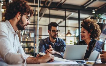 Small business team collaborating on IT solutions in a modern office