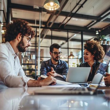 Small business team collaborating on IT solutions in a modern office