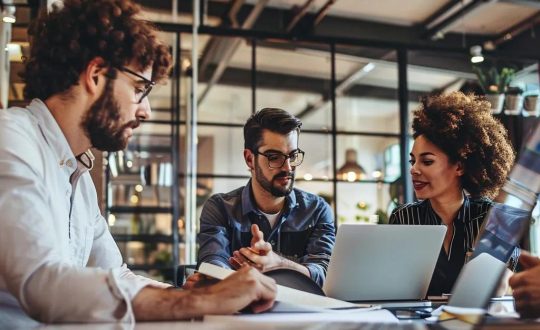 Small business team collaborating on IT solutions in a modern office